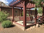 The outdoor patio is shaded by a pergola